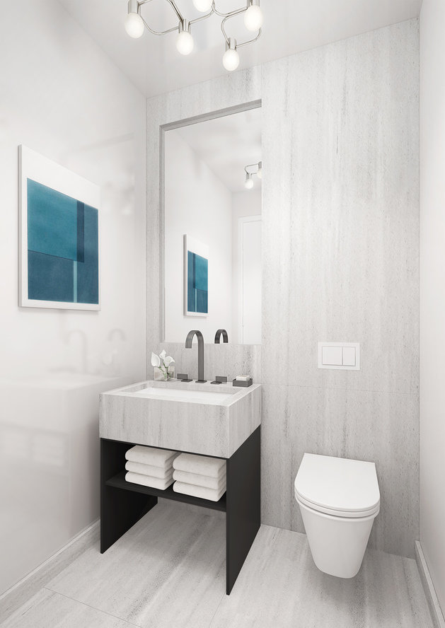 Modern powder room with white marble walls and floor and coordinating sink vanity with wall-mounted toilet and chandelier.
