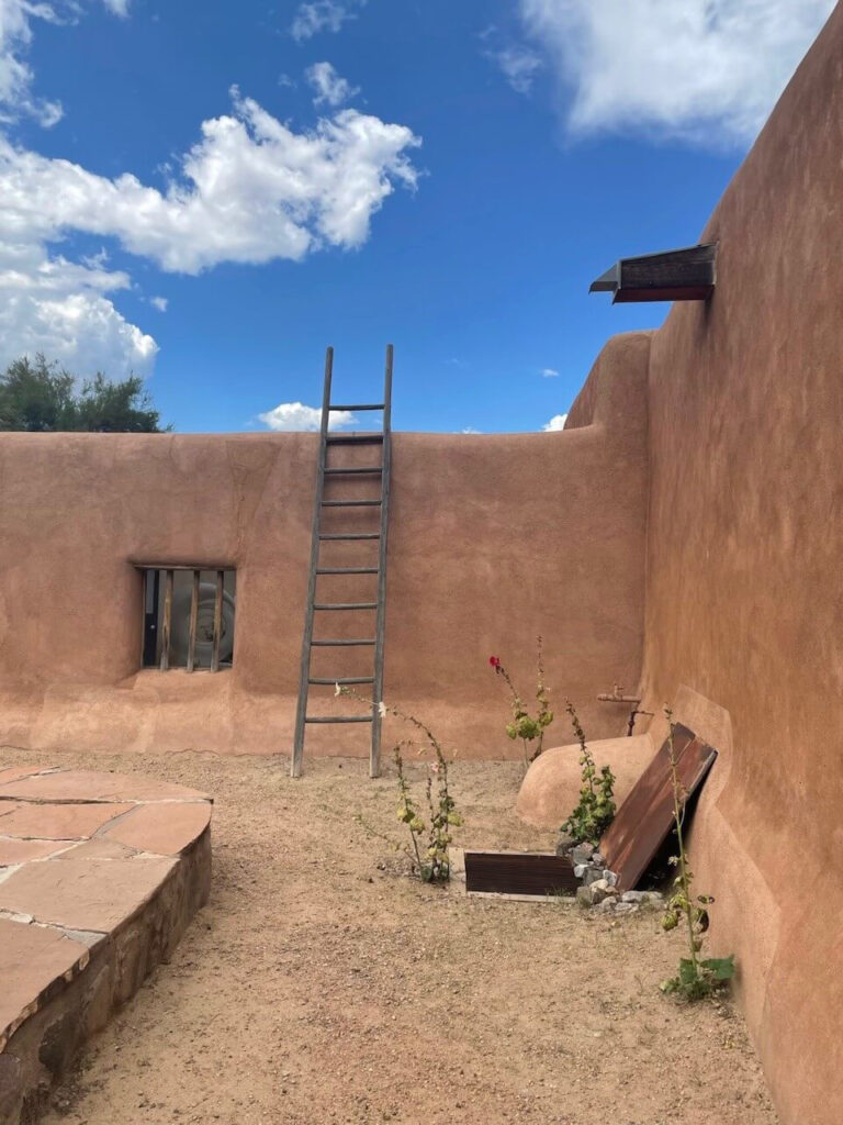 An adobe against a blue sky in Abiquiú, New Mexico which is the home and studio of Georgia O’Keeffe.