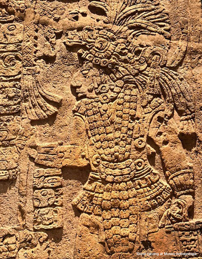 A large scale carving of a person in a suit or armor in a tan-colored stone.