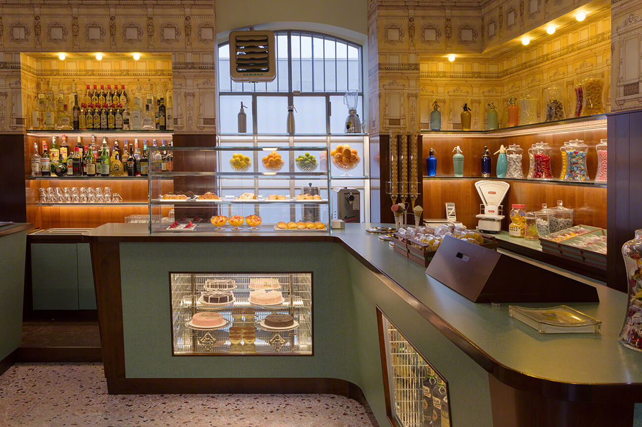 View of the counter at the well-known pasticceria in Milan, Marchesi 1824 showcasing pastries, fruits and candies and liquors.